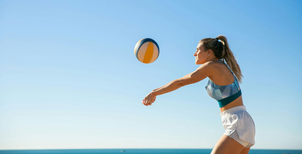 Girl playing beach volleyball